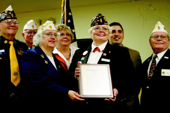 Cheri Stanton holds a plaque proclaiming her the Illinois Department of Veterans Affairs (IDVA) Veteran of the Month on Wednesday morning at the American Legion. The plaque was presented to her by IDVA Director Dan Grant.