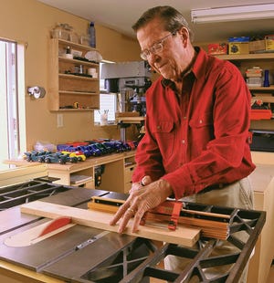 Earl Hausman cuts, shapes, sands and paints wooden toys and crosses that he gives to children.