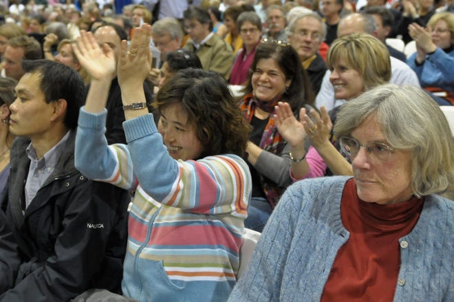 Voters cheer after the High School building project passes at special Town Meeting