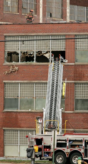 Rockford firefighters work to extinguish a fire Thursday, Nov. 19, 2009, at the Reed-Chatwood Building on Rock Street.