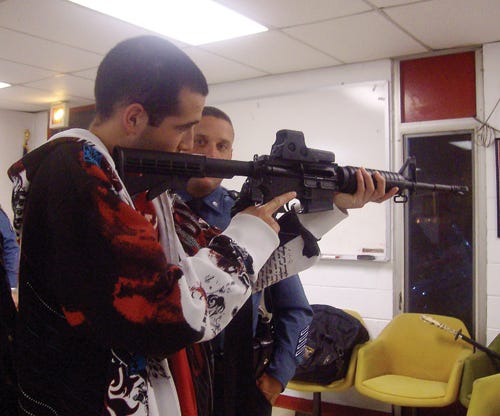 Citizens Police Academy student Jared Talbot tries an MP4 rifle after class.