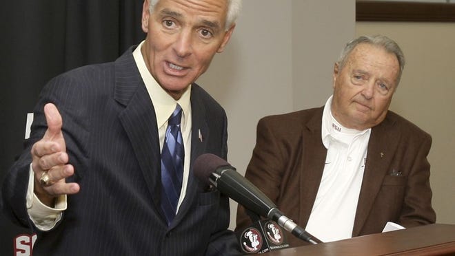 ORG XMIT: FLPC201 Gov. Charlie Crist, left, and Florida State University head football coach Bobby Bowden, right, attend a news conference regarding the child identification program, Wednesday, Nov. 18, 2009, in Tallahassee, Fla. The kits provide parents the means to collect information regarding their children's fingerprints, physical characteristics and picture. (AP Photo/Phil Coale)