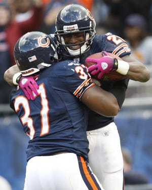 Chicago Bears running back Garrett Wolfe (right) celebrates his touchdown with fullback Jason McKie during the second half against the Detroit Lions in Chicago, Sunday, Oct. 4, 2009.