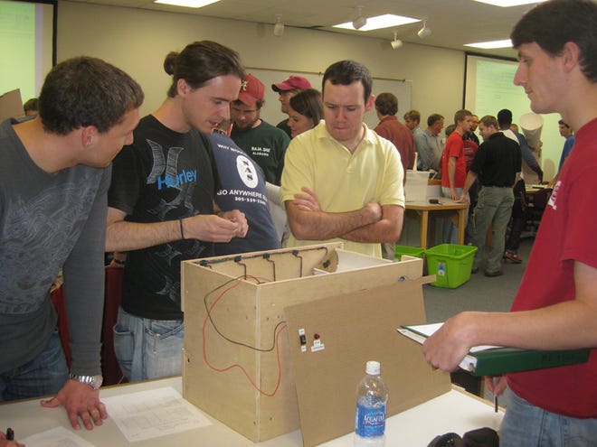 William Taylor, Andrew Browning, Andrew Truitt and Clayton Ishwood are members of the Green Going Gadget team that took part in the University of Alabama Mechanical Engineering Recycling Design competition. Students have designed devices that with the push of a button can sort plastic and glass bottles, aluminum and steel cans, and unclassified waste.