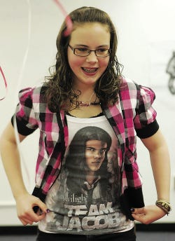Photo by Anna Murphey/New Jersey Herald Cassidy Zaruba, 14, of Lafayette, shows off her “Team Jacob” T-shirt at The Sussex County Library Just Us Teens Book Club celebration of the opening of the movie “New Moon,” based on the second book in the popular “Twilight” saga written by Stephenie Meyer, at the group’s last meeting. After discussing the book and the series, the group celebrated with a birthday cake honoring Bella, New Moon trivia, pin-the-tail-on-the-wolf and duct tape roses.