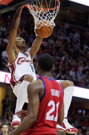 Cleveland Cavaliers' Jamario Moon, top, dunks on Philadelphia 76ers' Thaddeus Young (21) in the fourth quarter of an NBA basketball game Saturday, Nov. 21, 2009, in Cleveland. The Cavaliers won 97-91.
