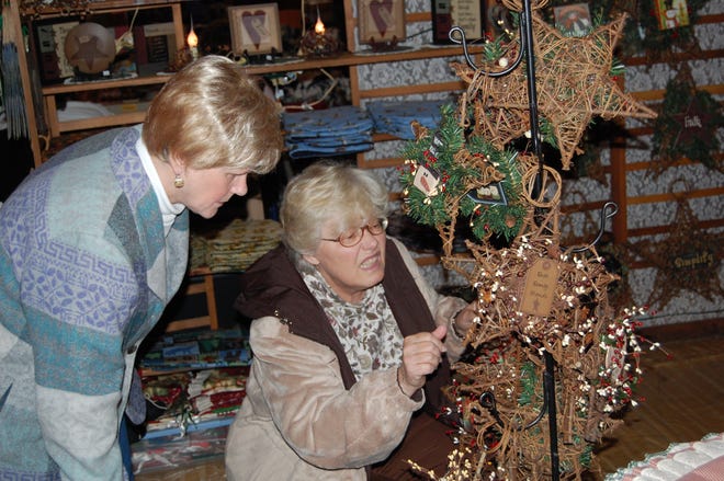 Sharon Ashley (left) and Barbara Marcin, both of Herkimer, check out some of the holiday decorations at the 25th Country Christmas Arts ‘n Crafts Bazaar in the gymnasium of West Canada Valley school district.