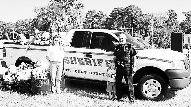 Teena Smith, Prudential staffer; Jonah Smith, 4; and Sheriff's Deputy Joe Bowen. Contributed photo