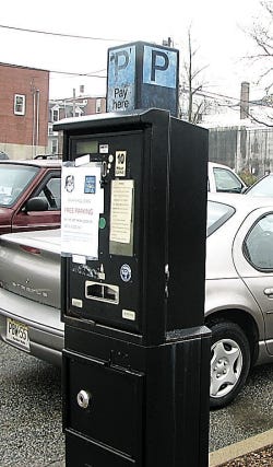 Photo by Tom Howell Jr./New Jersey Herald A pay-parking machine stands intact at the parking plaza on Trinity Street, in Newton. A similar machine on Adams Street was ripped from its mooring Monday by two Newton residents, police said.