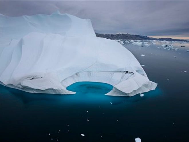 In this July 19, 2007 file photo, an iceberg is seen melting off the coast of Ammasalik, Greenland. Since an agreement to reduce greenhouse gas pollution was signed in Kyoto, Japan, in Dec. 1997, the level of carbon dioxide in the air has increased 6.5 percent. Officials from across the world will convene in Copenhagen next month to seek a follow-up pact, one that President Barack Obama says "has immediate operational effect...an important step forward in the effort to rally the world around a solution."