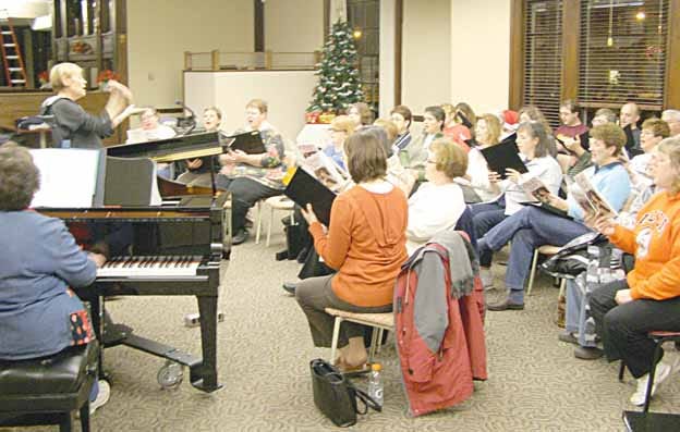 Sue Sagmoen directs the Black Hawk East Community Choir in a rehearsal for its Christmas presentation, “Hollyfest. . .Music and Literature for the Christmas Season.”