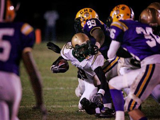 Lincoln High wide receiver Michael Reynolds, center, gets his face mask pulled by Columbia High defensive lineman Curtis Washington, top center, for a Columbia High penalty during the first half at Columbia High School on Friday, November 27, 2009