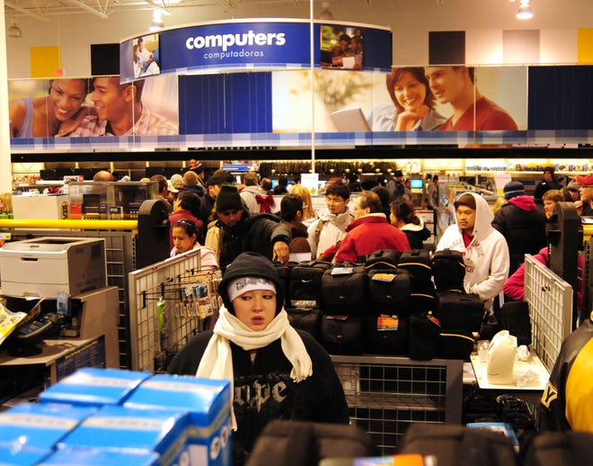 Bundled up customers fill the aisles at Best Buy during the Black Friday door buster sales.