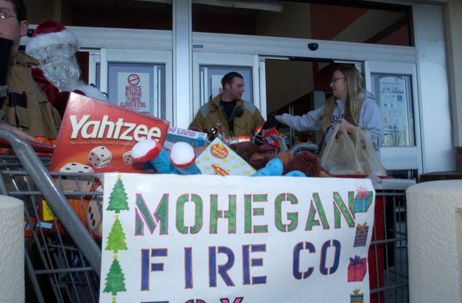 Fifth Annual Mohegan Fire Company Toy drive to benefit the Town of Montville Social Services Christmas Program, Saturday, November 28, 2009, in front of the Uncasville Stop and Shop. Photo by Dieu To/ Norwich Bulletin