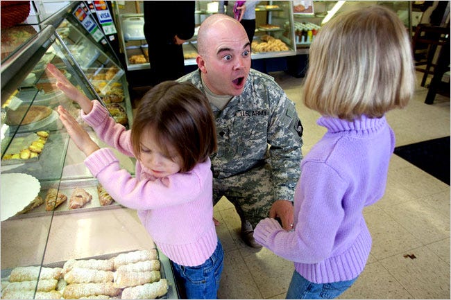 TEARS OF JOY Chris Weir, just back from Iraq, greets his daughters, Kylee, 6, Ashlyn, 4, in Cleveland, Tenn.