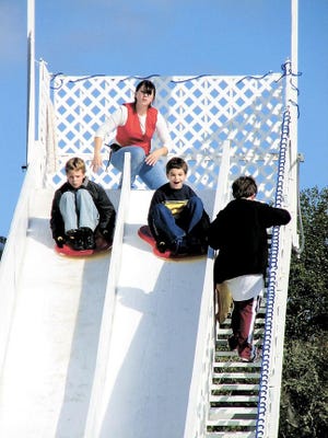 Visitors to Winter Wonderland go down the ice slide at the St. Augustine Amphitheatre.