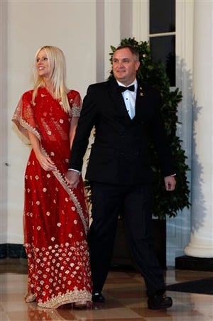 In this Tuesday, Nov. 24, 2009 file photo, Michaele and Tareq Salahi, right, arrive at a State Dinner hosted by President Barack Obama for Indian Prime Minister Manmohan Singh at the White House in Washington. This time, the picture is the story. After the Secret Service insisted that President Barack Obama was never endangered by a security breach that allowed a couple to crash his first state dinner, the White House has released a photo showing that not only did the pair get close to Obama, they actually shook hands and talked to him.