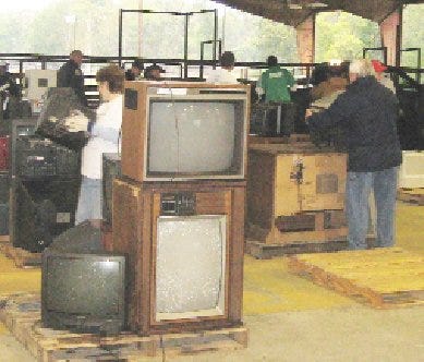 Volunteers collect and sort old televisions and electronic equipment on Saturday, Nov. 21 during the TV/Electronics Collection day at the Ascension Civic Center in Sorrento.