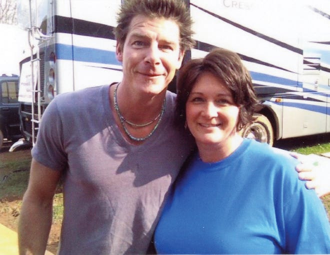 Beth Swicegood (right) pictured with Ty Pennington, host of 'Extreme Makeover: Home Edition,' volunteered to help finish the interior of the Creasey family's new home.