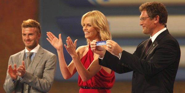 FIFA secretary general Jerome Valcke holds up the name South Africa as Actress Charlize Theron and England soccer player David Beckham applaud during the 2010 World Cup draw in Cape Town, South Africa, on Friday.