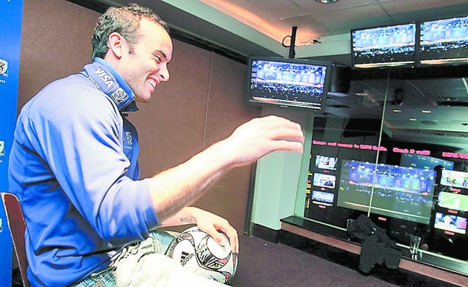 U.S. soccer player Landon Donovan reacts as he watches the World Cup draw ceremony from South Africa Friday at the Visa sponsored event at New York's ESPN Zone. AP photo
