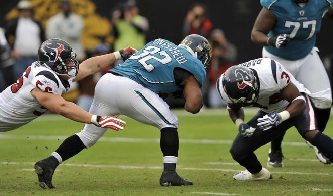 WILL DICKEY/The Times-UnionJaguars running back Maurice Jones-Drew (32) puts his head down as he runs for yardage against the Houston Texans on Sunday in the Jaguars' 23-18 victory.