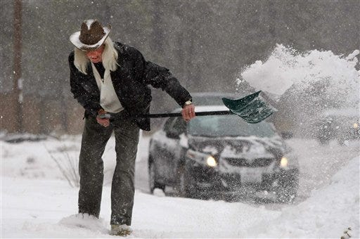Mike Drysdale clears snow from the driveway of his home near Big Bear City, Calif., Monday, Dec. 7, 2009. A cold storm passed through Southern California, swelling rivers, causing hundreds of traffic accidents and prompting the temporary evacuation of nine Los Angeles canyon homes.