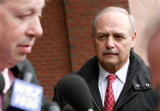 Former Massachusetts House Speaker Sal DiMasi, right, listens to his attorney Thomas Kiley speak outside federal court after DiMasi pleaded not guilty to federal corruption charges Thursday, Nov. 12, 2009, in Boston.