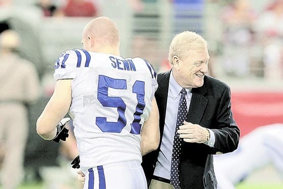 Indianapolis Colts team president Bill Polian, right, shakes hands with Jordan Senn (51) prior to a Sept. 27 game against the Arizona Cardinals in Glendale, Ariz. Polian won a Super Bowl in 2006 and now has put together a Colts team with a record-tying 21 consecutive regular-season wins. AP Photo