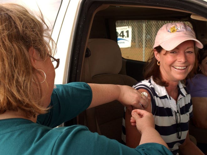 TERRY DICKSON/The Times-UnionSherry Dillard was all smiles after she decided to "tough it out" and get a swine flu shot instead of the nasal mist. Nurse Jennifer Dillman administered the vaccine. Dillard, who came through the county Health Department's drive-through clinic, says she does not like needles.