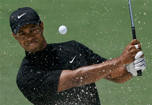 This is an April 11, 2008, file photo showing Tiger Woods hitting out of a bunker on the second hole during the second round of the 2008 Masters golf tournament at the Augusta National Golf Club in Augusta, Ga. Tiger Woods has won more major championship than anyone except Jack Nicklaus. He has won more PGA Tour events than anyone except four of the greatest golfers in history. Such dominance is what makes Woods a candidate for The Associated Press' Athlete of the Decade.