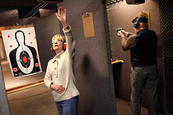 Beverley Jenkins, left and her husband Jerry Jenkins shoot handguns at Guns and Leather, a firearms store and shooting range, Friday in Greenbrier, Tenn. A nationwide review by The Associated Press found that over the last two years, 24 states, mostly in the South and West, have passed 47 new laws loosening gun restrictions.