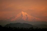 In this Jan. 29, 2007 file photo, Mount Hood is shown as the sun sets in Portland, Ore. Crews on Saturday found the body of a climber missing on Oregon's Mount Hood but two others were still missing nearly two days after the three set out to climb the west side of the 11,000-foot peak, a sheriff's spokesman said.