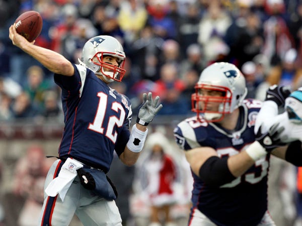 New England Patriots quarterback Tom Brady (12) throws the ball as he gets protection from New England Patriots guard Dan Connolly (63) against the Carolina Panthers during the first quarter of an NFL football game in Foxborough, Mass., Sunday, Dec. 13, 2009. (AP Photo/Elise Amendola)