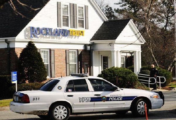 The Yarmouth police investigate a robbery at the Station Avenue Rockland Trust yesterday. No word on how much was stolen.