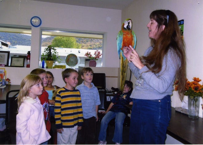 Above,?Mattole student Morgan Young (far left) brought Hercules, a brightly colored Macaw parrot, in to class recently. Her mother Tina, a registered veterinary technician, explained parrot behaviors and fielded student questions. Hercules even permitted the children to pet him. Other students from left are Keegan Silva, Breanna Fisher, Nathan Branson, Andy Allen and Rosalyn Ray.