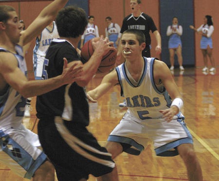 Lakeland’s Jake Sirk (5) and Kole Heller (21) defend Tuesday in the Lakers’ nine point win.