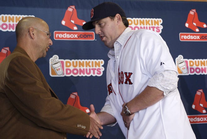 New Red Sox pitcher John Lackey (right) shakes hands with manager Terry Francona at a press conference announcing his signing.