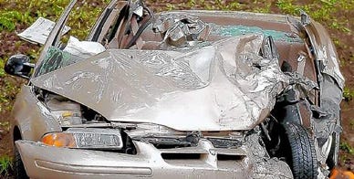 A Dodge sedan involved in a two-car head-on crash May 11 sits on the side of Route 209 in Brodheadsville.