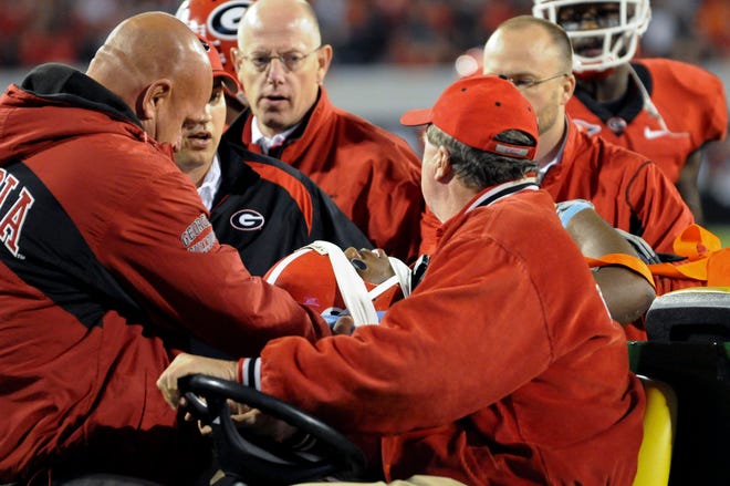 20091114 - Athens, Ga : Georgia safety Bacarri Rambo (18) is tended to by trainers who help him to a cart after an injury near the goal line late in the fourth quarter at Sanford Stadium during the UGA vs. Auburn football game on Saturday, Nov. 14, 2009. Georgia won, 31-24. David Tulis, OnlineAthens/Banner-Herald
