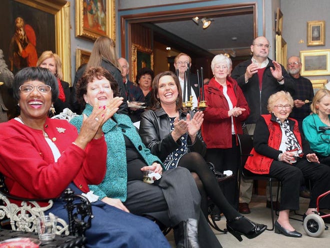 Attendees at a reception for the United Way Campaign applaud after the total amount raised in the 2009 campaign was revealed on Thursday at the Westervelt-Warner Museum.