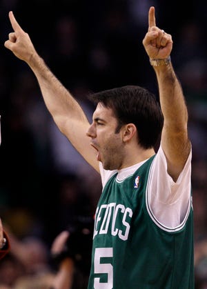 Chris Miller, of Quincy, Mass., reacts after hitting a half-court basket worth $50,000 during a timeout in an NBA basketball game between the Boston Celtics and Philadelphia 76ers in Boston on Friday.