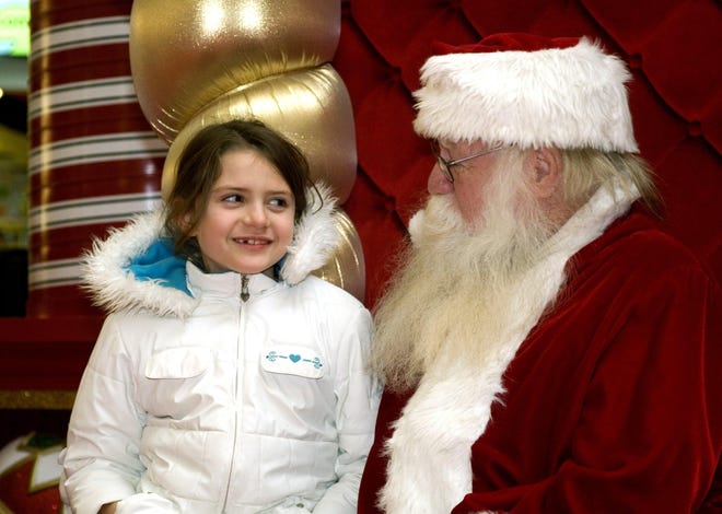 Hailey LaBrake, of Colchester, tells Santa what she wants for Christmas Friday at the Crystal Mall in Waterford.