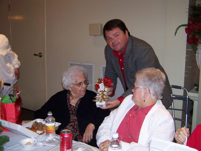 Rotary President Chuck Long awards Hilda Dugas, 96 with a gift. Dugas was the oldest member in the building at the Senior Luncheon last Thursday.