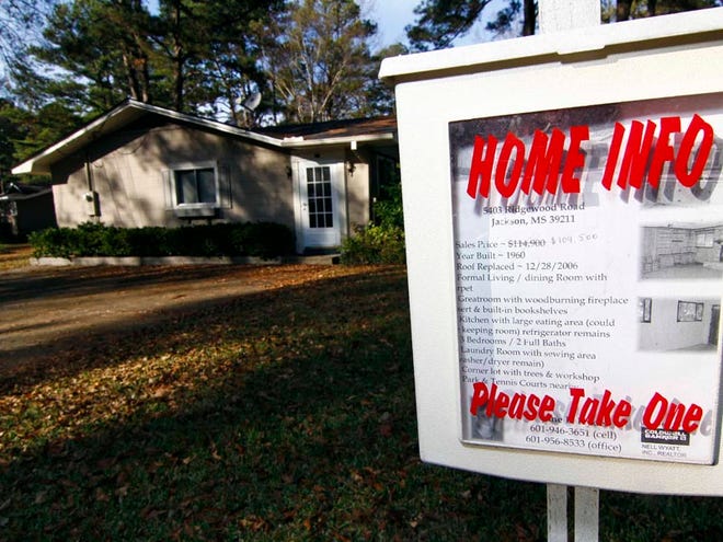 A box containing info about a home with a reduced price for sale in Jackson, Miss. is shown Tuesday, Dec. 22, 2009. Sales of previously occupied homes surged in November to the highest level in nearly three years, spurred by federal subsidies for starter homes and a massive Federal Reserve push to drive down mortgage rates.