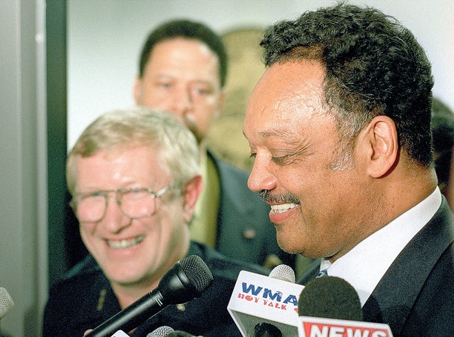 Rev. Jesse Jackson and Springfield Police Chief John Harris talk to the press after their meeting with Mayor Karen Hasara in May 2002.
