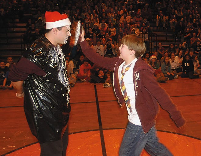 Northside Blodgett guidance counselor Mark Pronti braces to receive a pie in the face from seventh grader Eddie Kimble.