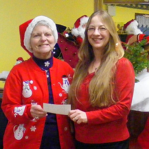 Joan Gilbert, left, treasurer of the Country Gardeners presents a check to Carleen Faatz, community services director, for the Wayne County Children's Christmas Bureau.