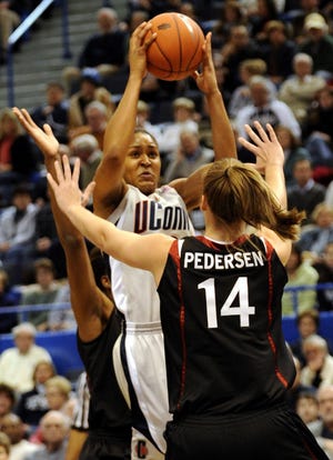 Stanford's Kayla Pedersen defends as Connecticut's Maya Moore shoots during the first half of an NCAA women's college basketball game in Hartford, Conn., on Wednesday, Dec. 23, 2009.