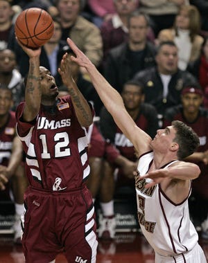 UMass guard and former Newton North star Anthony Gurley shoots over BC's Joe Trapani during last night's game at Conte Forum.